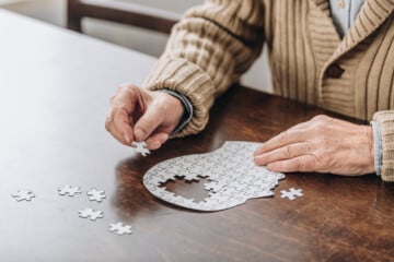 cropped view of senior man playing with puzzles
